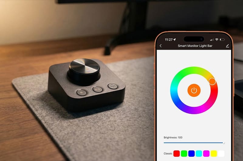 Wireless dimmer on the desk next to the Striva app on a phone