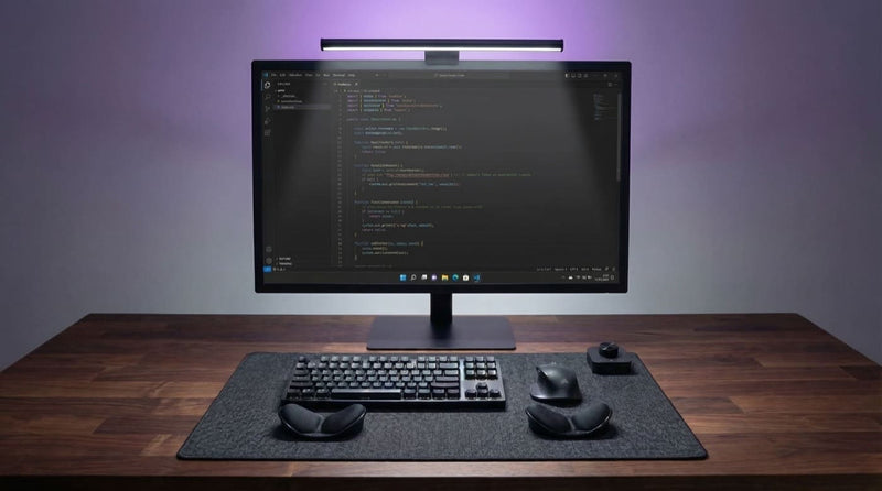 Desk with Striva Light Bar — evenly lit, no glare
