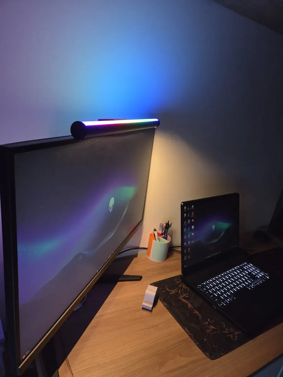 Striva Light Bar on a flat monitor next to a laptop